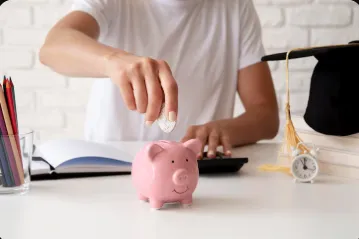 Person putting money in piggy bank