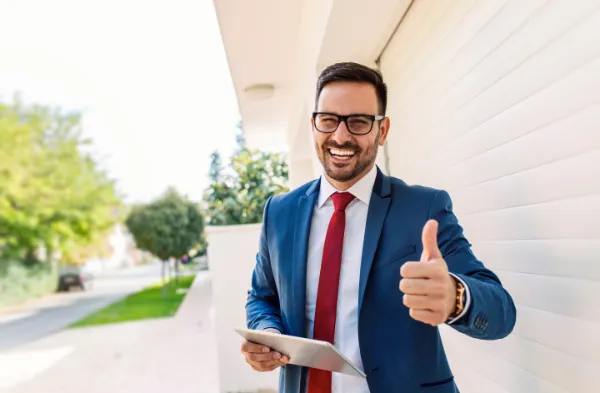Happy businessman giving thumbs up