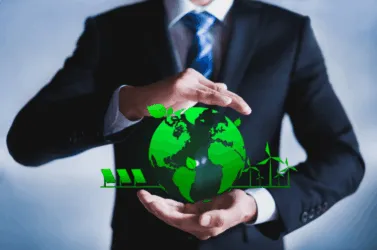 Person holding a green globe symbolizing energy savings, cost efficiency, and eco-friendly off-peak operation