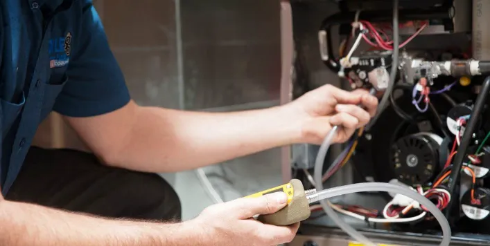 technician doing maintenance of water heater