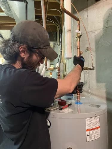 plumber checking storage heater