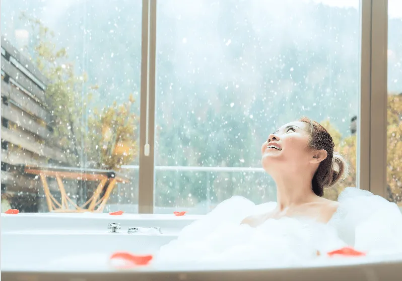 Women taking shower in hot water tub